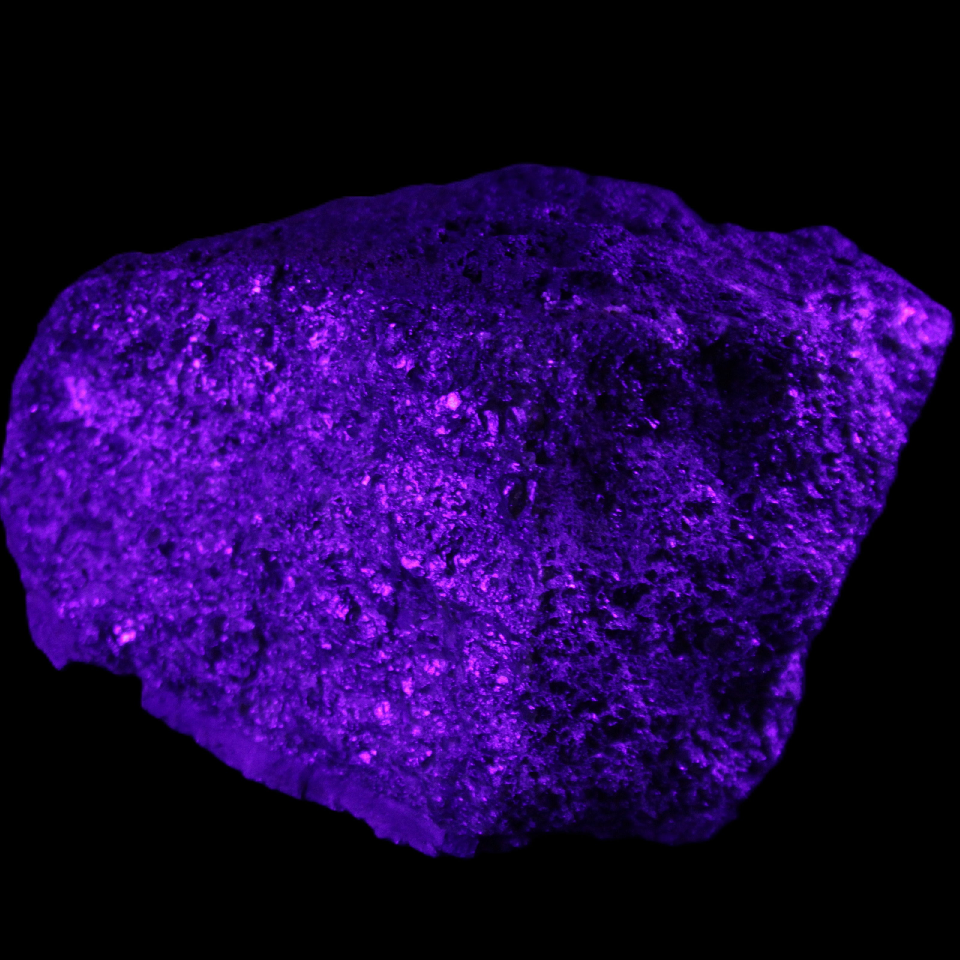 Olivine pyroclastic volcanic bomb from Central Victoria 116*81*65mm 930g in UV light - Rocks and Things Store