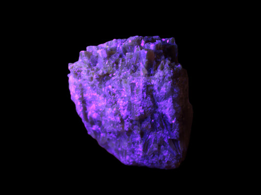 Amber Calcite phosphorescent cluster 133g in UV light