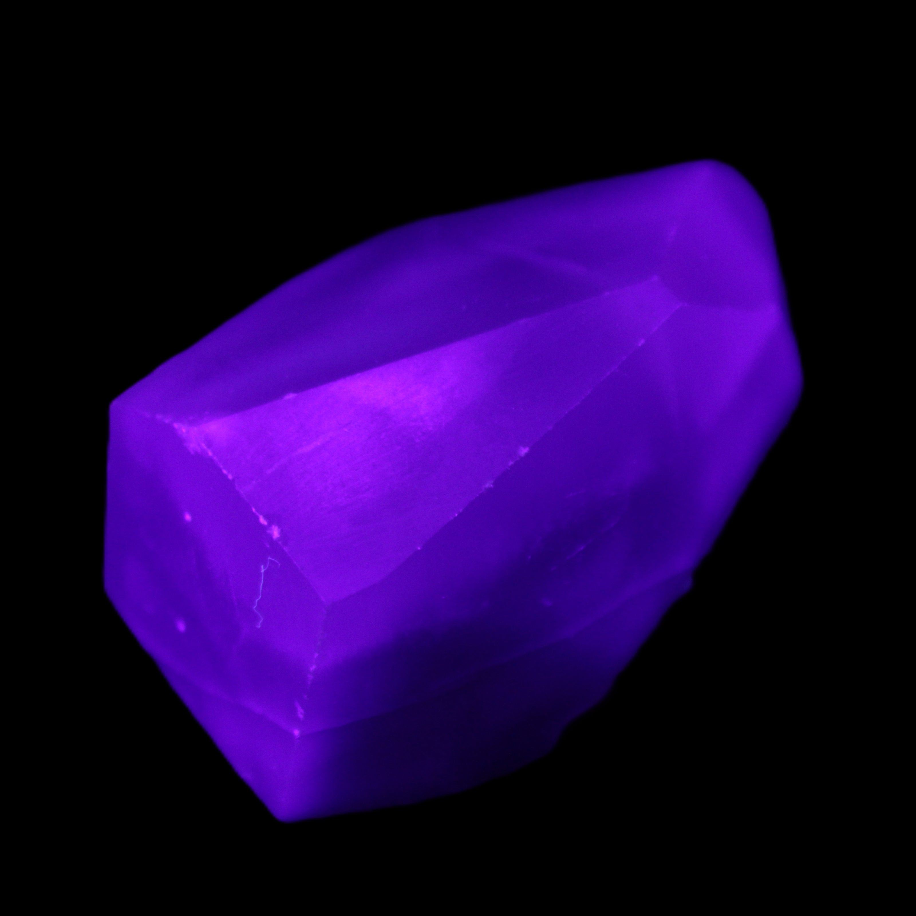 Purple Fluorite polished polygon 82g in UV light - Rocks and Things Store