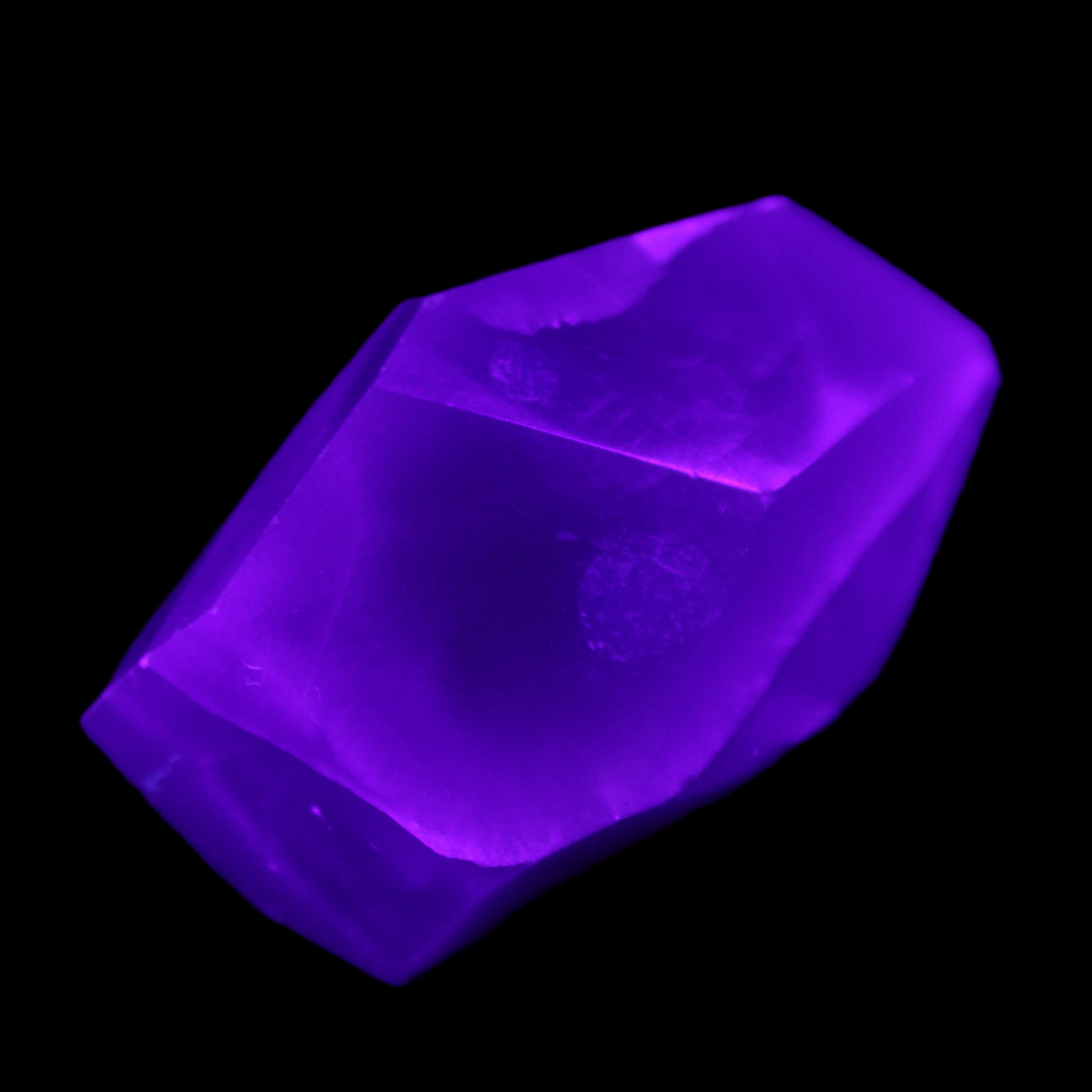 Purple Fluorite polished polygon 82g in UV light - Rocks and Things Store