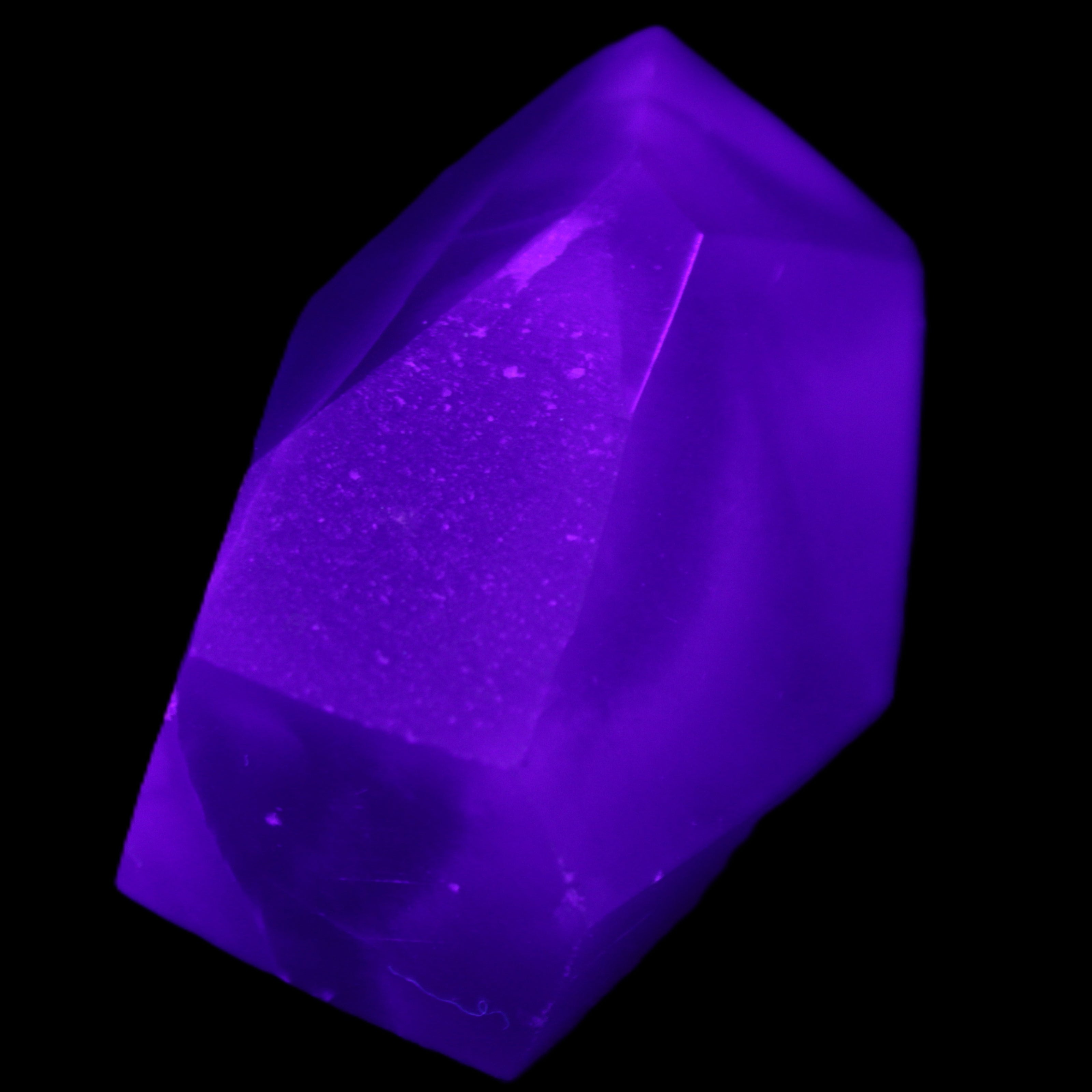 Purple Fluorite polished polygon 82g in UV light - Rocks and Things Store