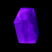 Purple Fluorite polished polygon 82g in UV light - Rocks and Things Store