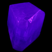 Purple Fluorite polygon 201g in UV light - Rocks and Things Store
