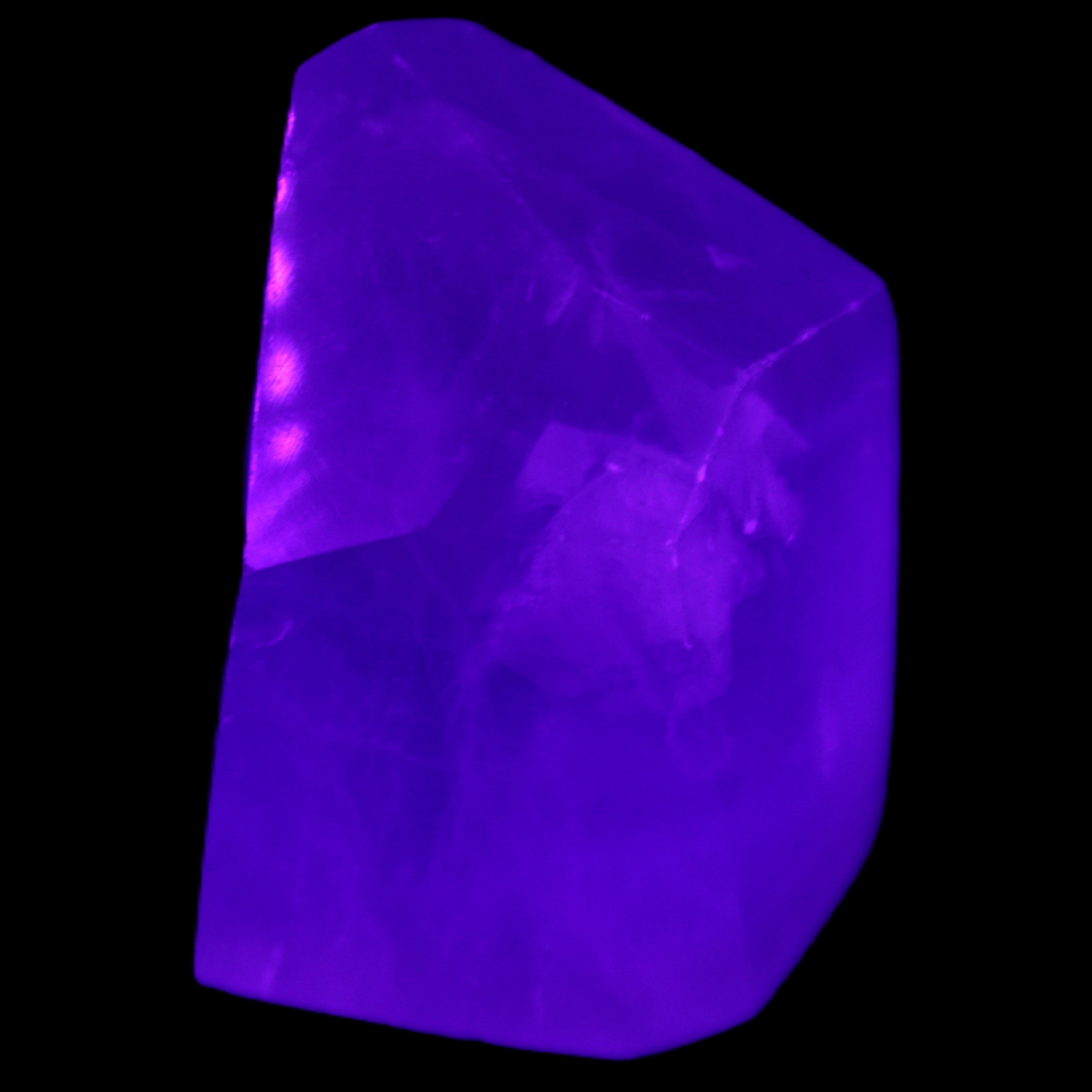 Purple Fluorite polygon 201g in UV light - Rocks and Things Store