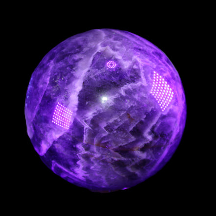 Chevron Fantasy Amethyst sphere 1389g in sunlight - Rocks and Things Store