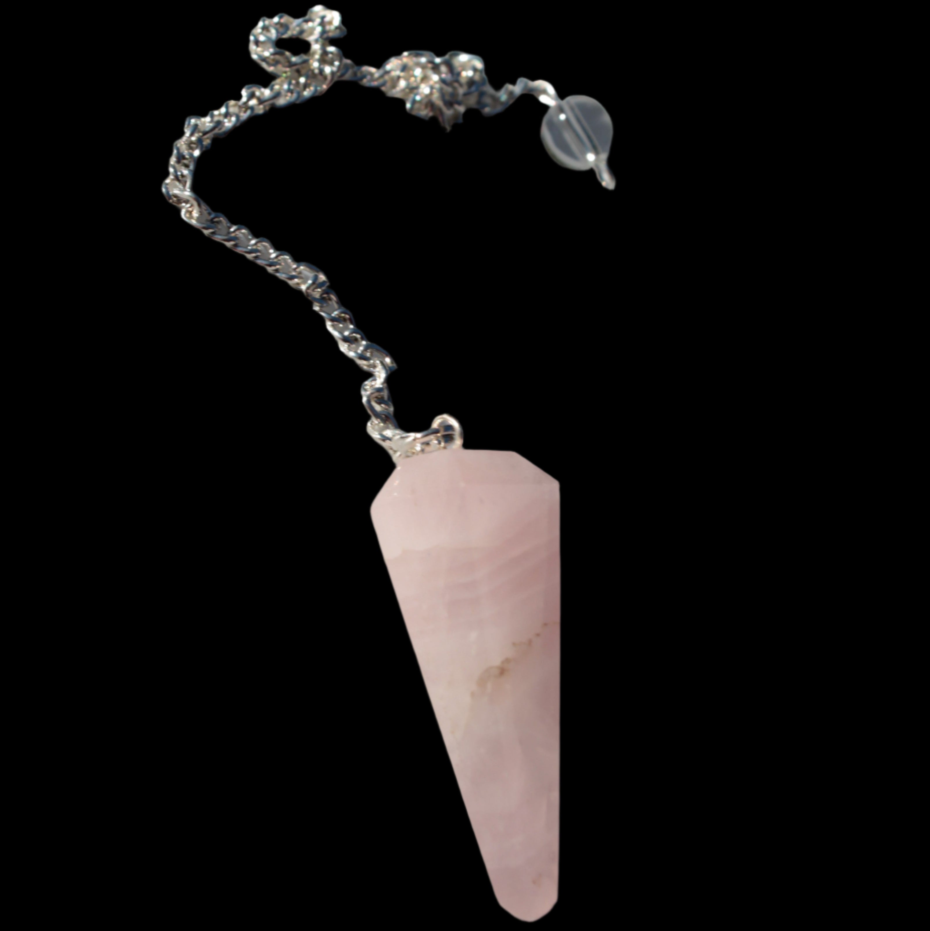 Rose Quartz faceted cone dowsing pendulum 34mm 9g in sunlight - Rocks and Things Store