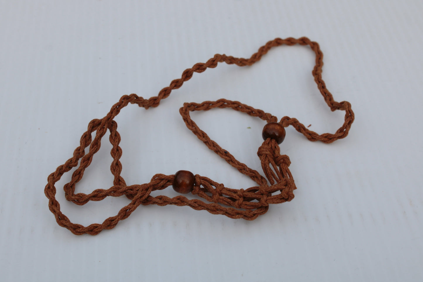 Large brown stone-holder rope cage Rocks and Things