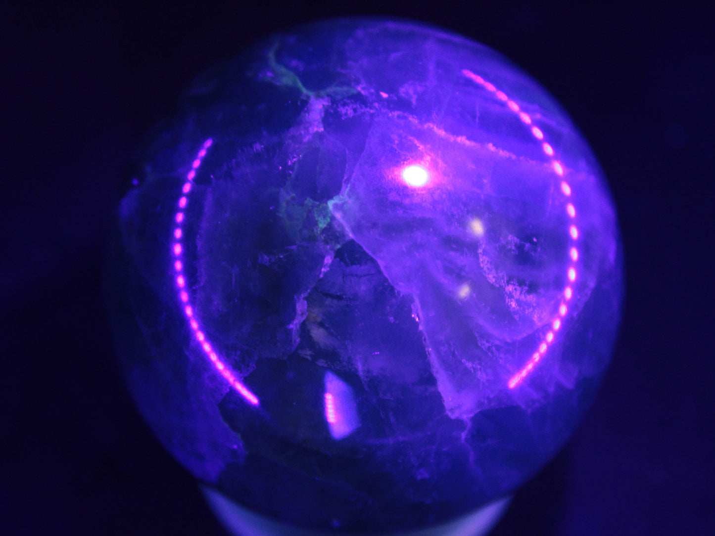 Green Fluorite sphere 427g in UV light