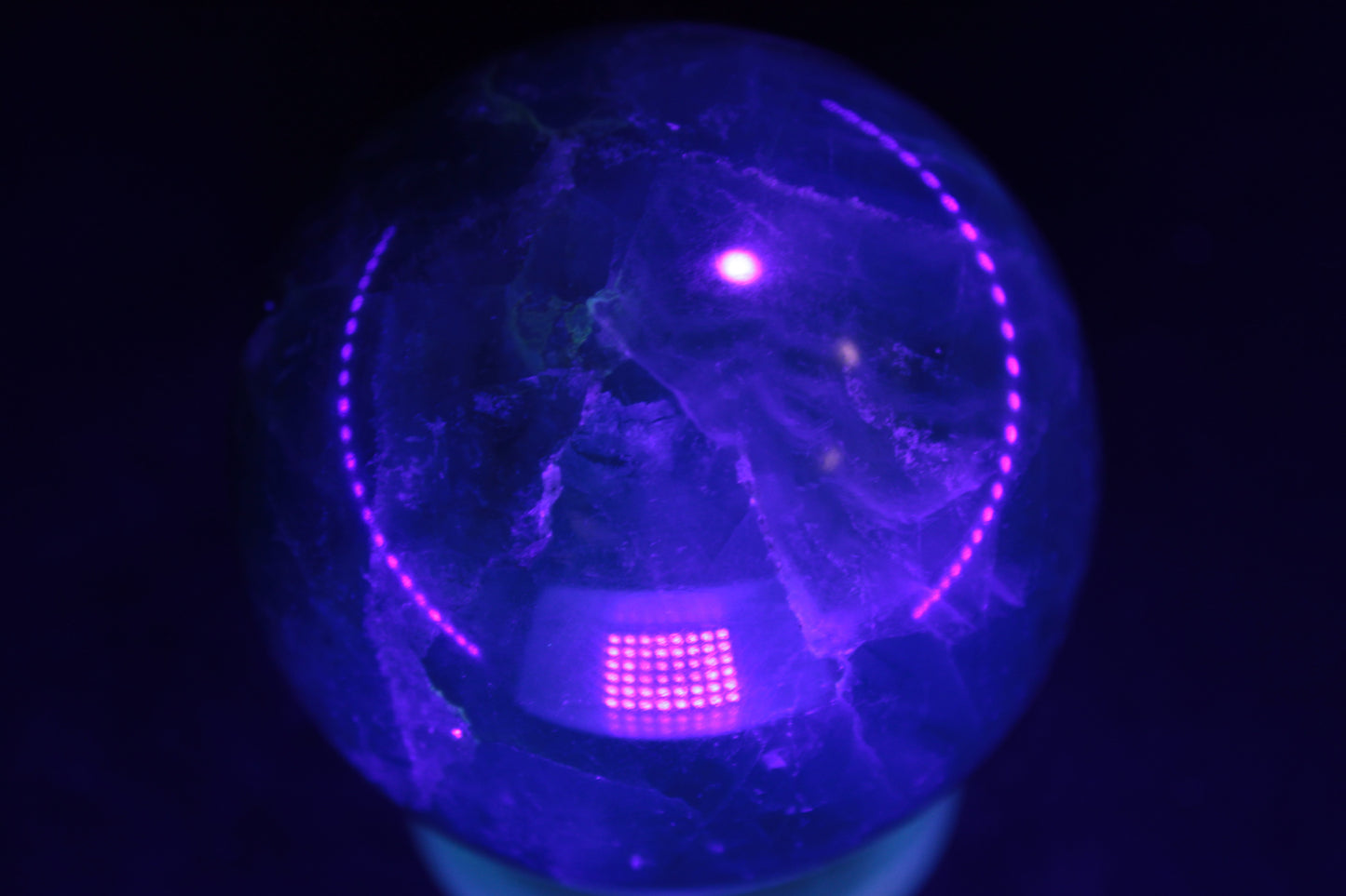 Green Fluorite sphere 427g in UV light