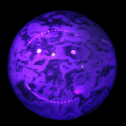 Moss Agate sphere 335g in UV light