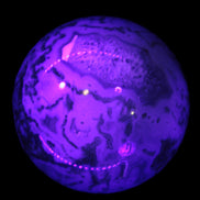 Moss Agate sphere 335g in UV light