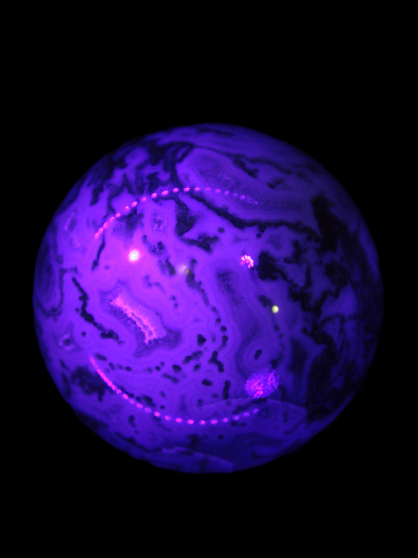 Moss Agate sphere 335g in UV light