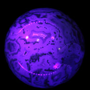 Moss Agate sphere 335g in UV light