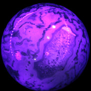 Moss Agate sphere 335g in UV light