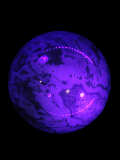 Moss Agate sphere 335g in UV light
