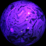 Moss Agate sphere 335g in UV light