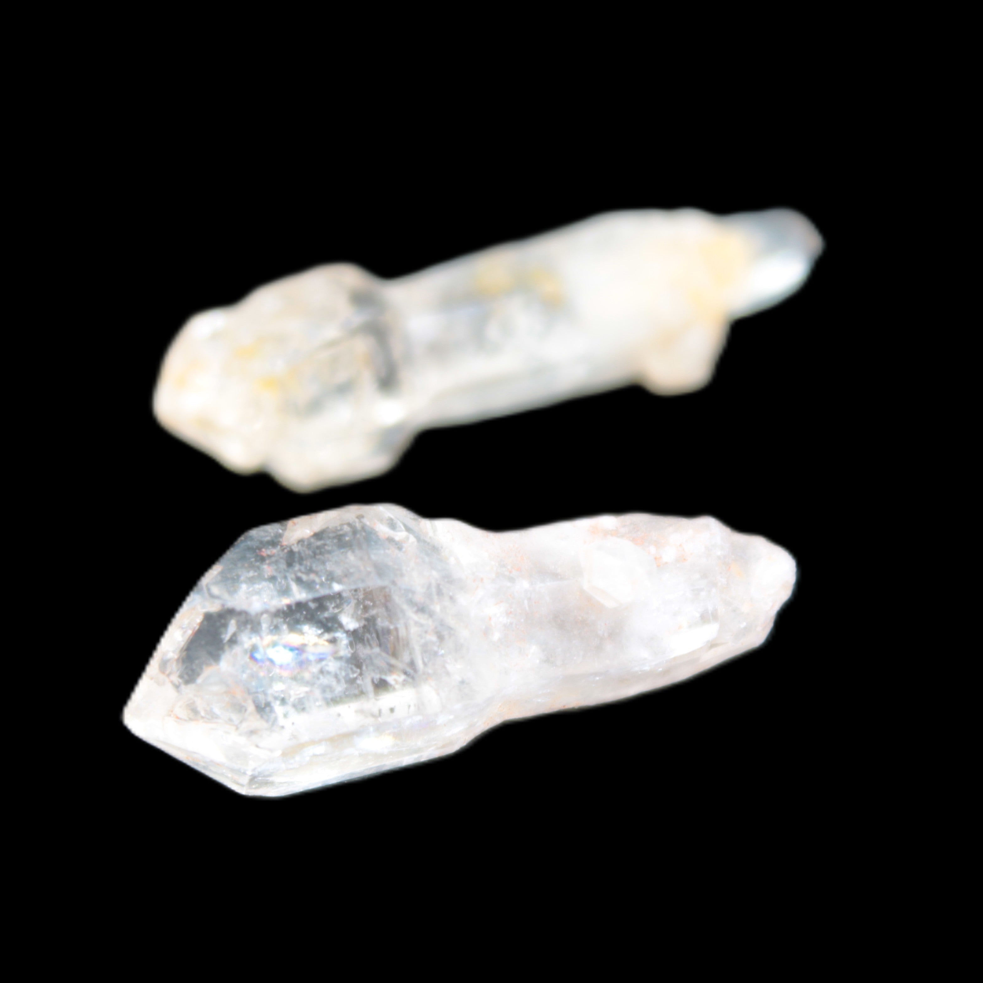 Two sceptre crystals with bridges, enhydro & hydrocarbons 5.3g in bright sunlight