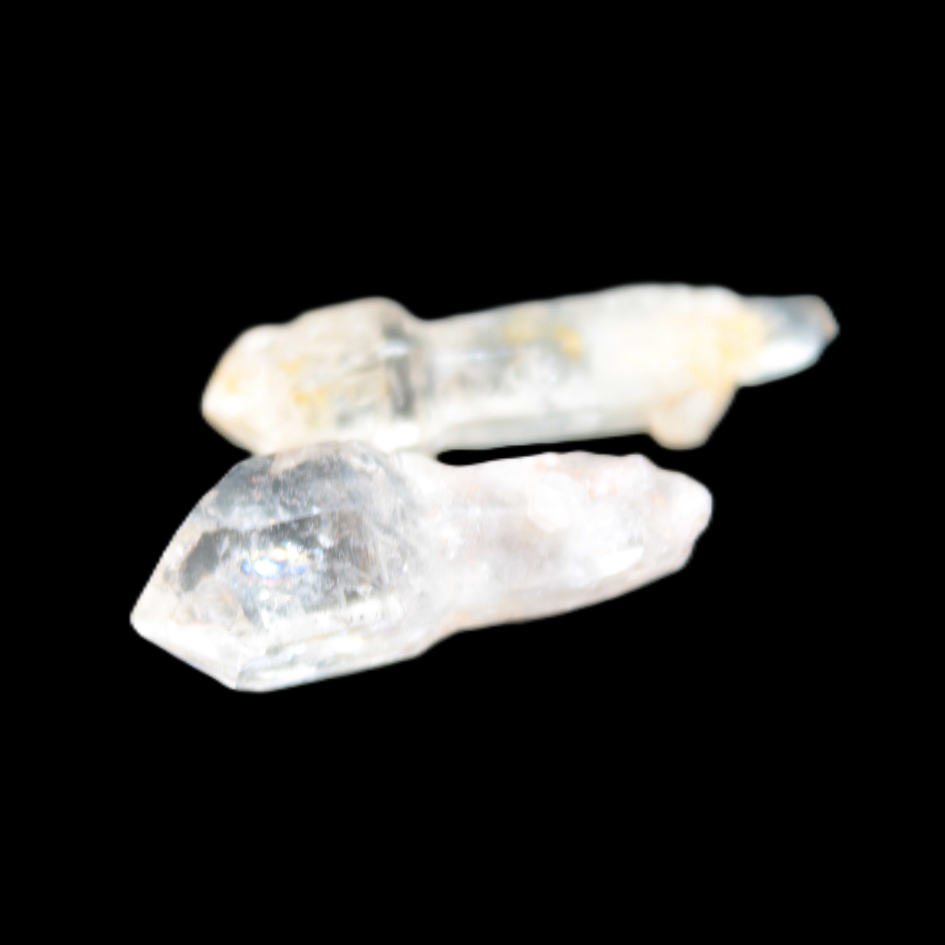 Two sceptre crystals with bridges, enhydro & hydrocarbons 5.3g in bright sunlight