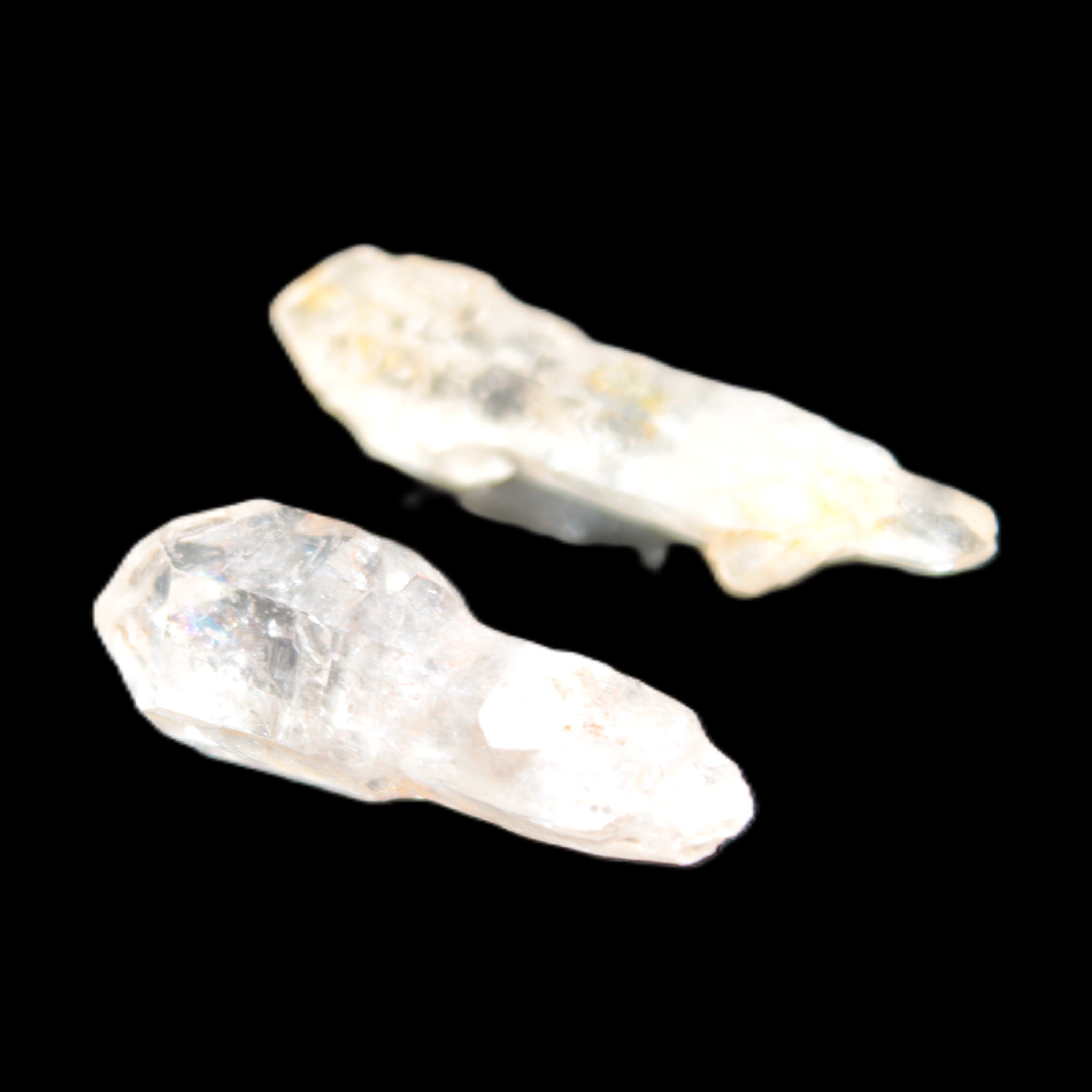 Two sceptre crystals with bridges, enhydro & hydrocarbons 5.3g in bright sunlight
