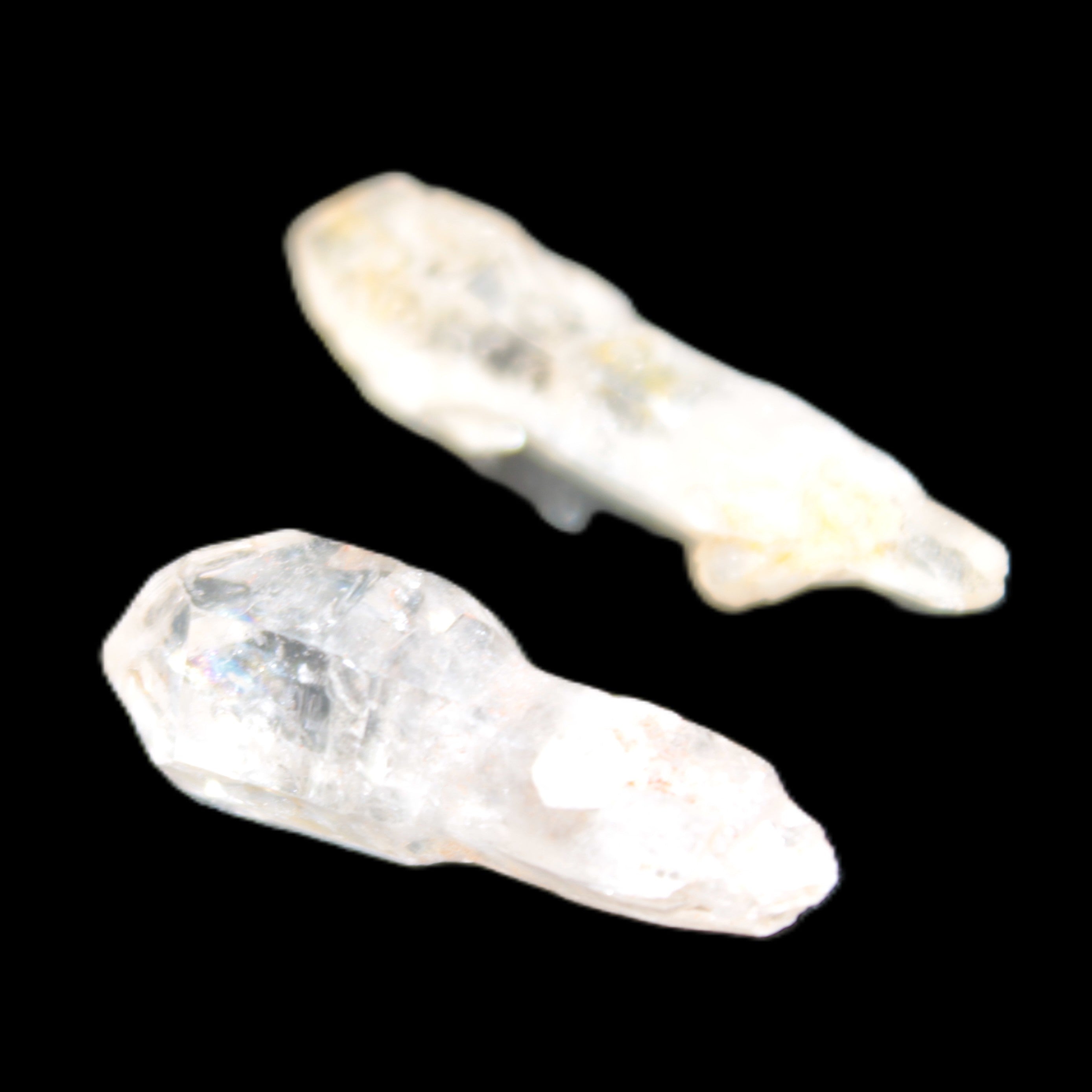 Two sceptre crystals with bridges, enhydro & hydrocarbons 5.3g in bright sunlight