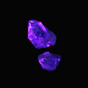 Fenster Quartz Two stubby double terminated crystals 4.4g in UV light