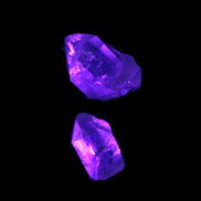 Fenster Quartz Two stubby double terminated crystals 4.4g in UV light