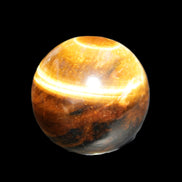 Golden Tigers Eye sphere 35mm 59g in sunlight - Rocks and Things Store