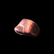 Red Tigers Eye tumbled stone 26/28mm 11/13g in sunlight - Rocks and Things Store