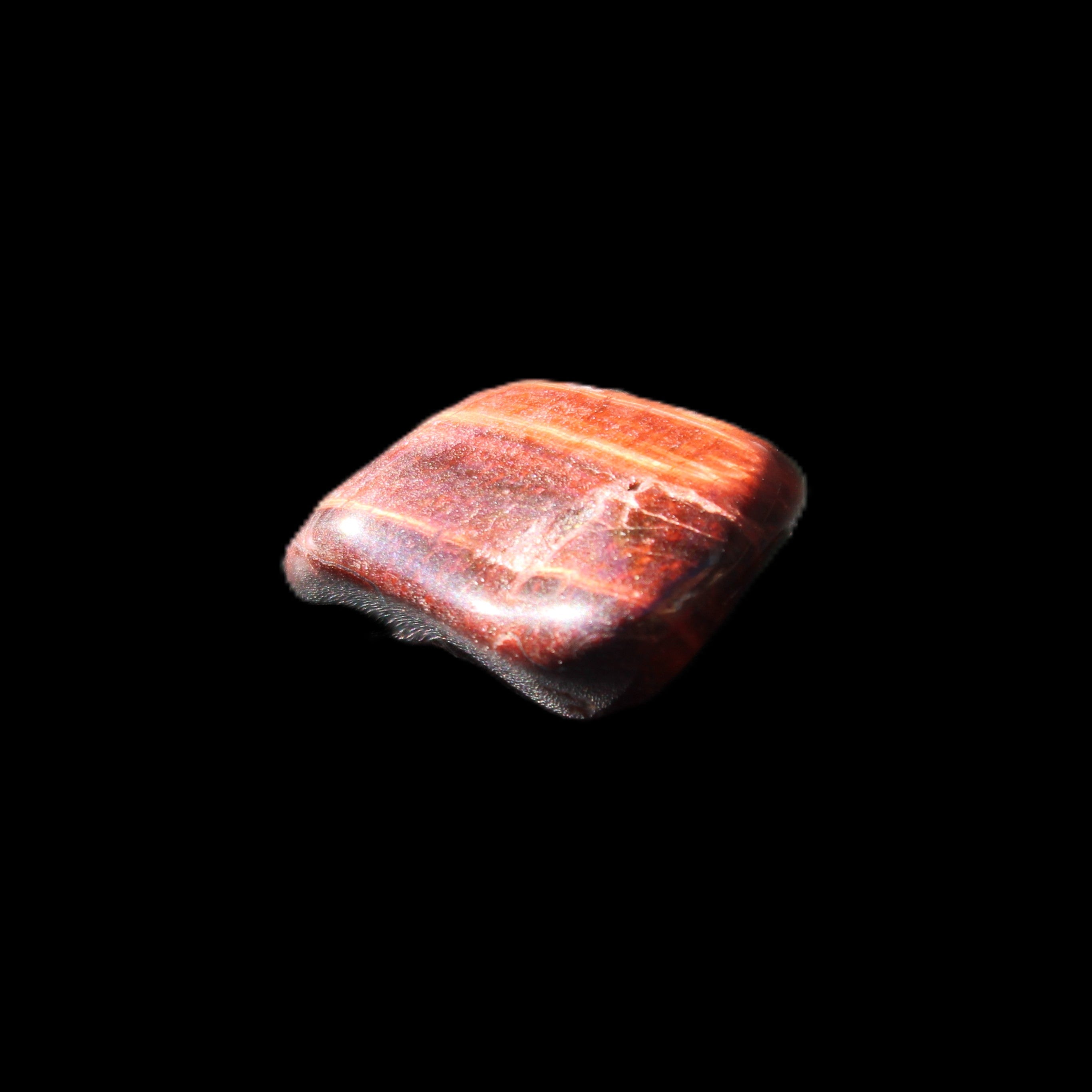 Red Tigers Eye tumbled stone 26/28mm 11/13g in sunlight - Rocks and Things Store