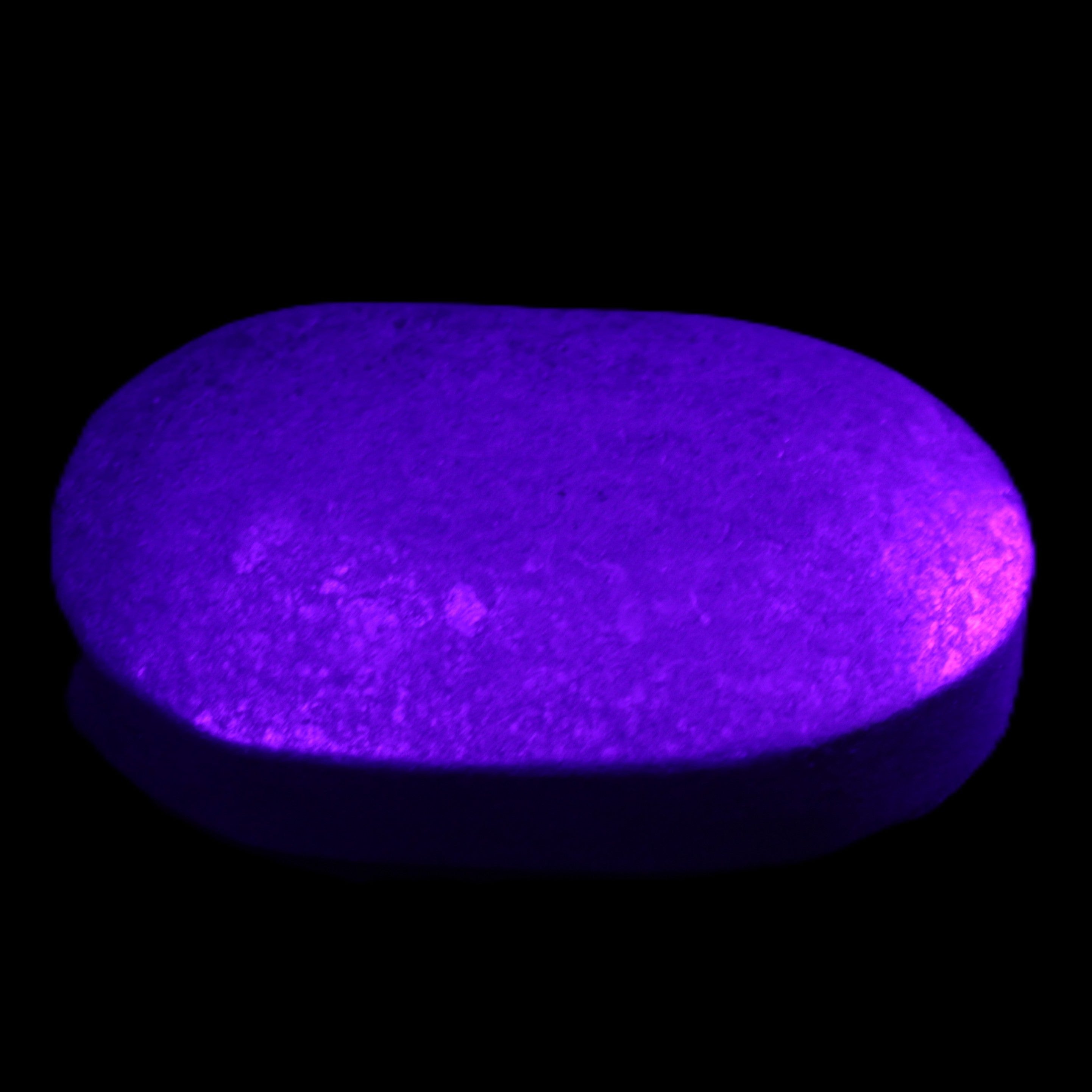 Shungite palmstone 63*40mm 56g in UV light - Rocks and Things Store