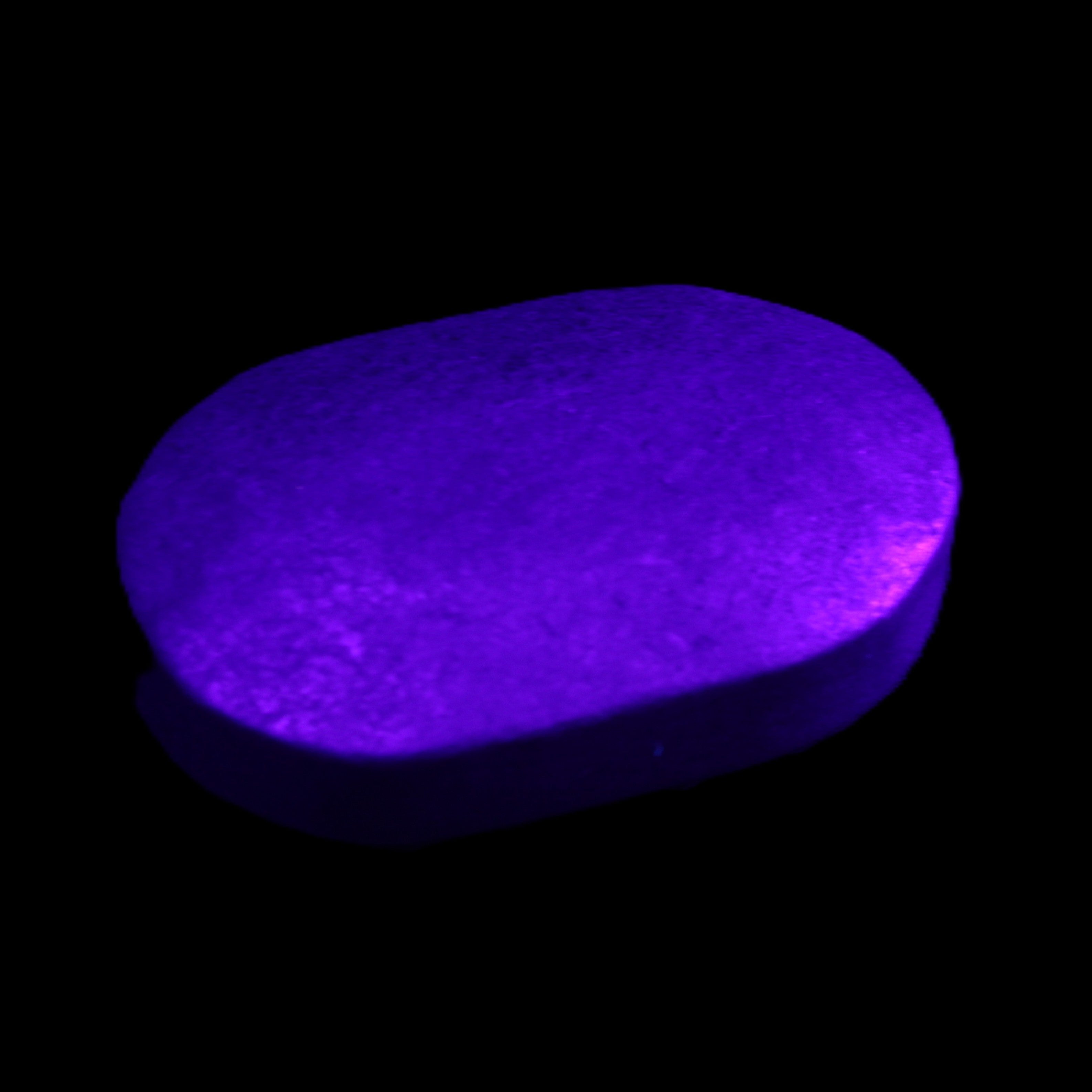 Shungite palmstone 63*40mm 56g in UV light - Rocks and Things Store