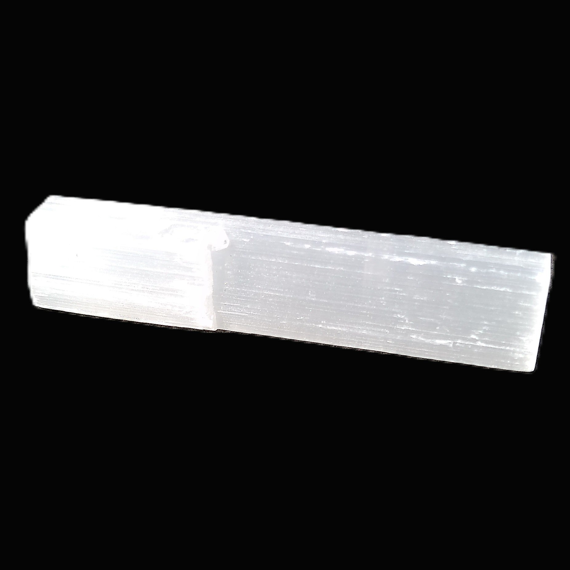 Selenite rod 55mm 7/9g in sunlight - Rocks and Things Store