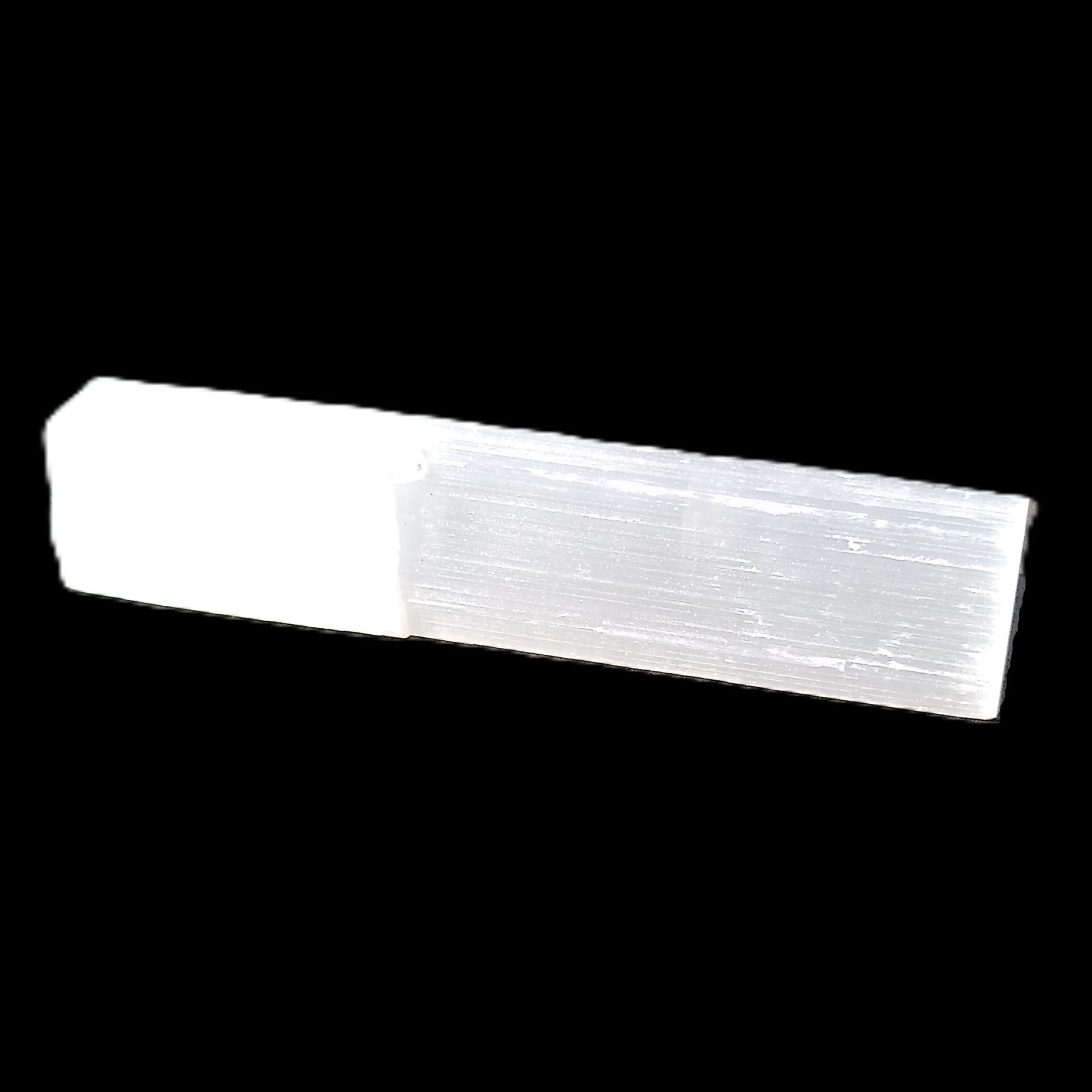 Selenite rod 55mm 7/9g in sunlight - Rocks and Things Store
