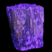 Amber Calcite phosphorescent crystal 127g in UV light - Rocks and Things Store