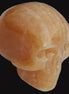 Banded Yellow Calcite skull 49mm 185.6g in sunlight - Rocks and Things Store