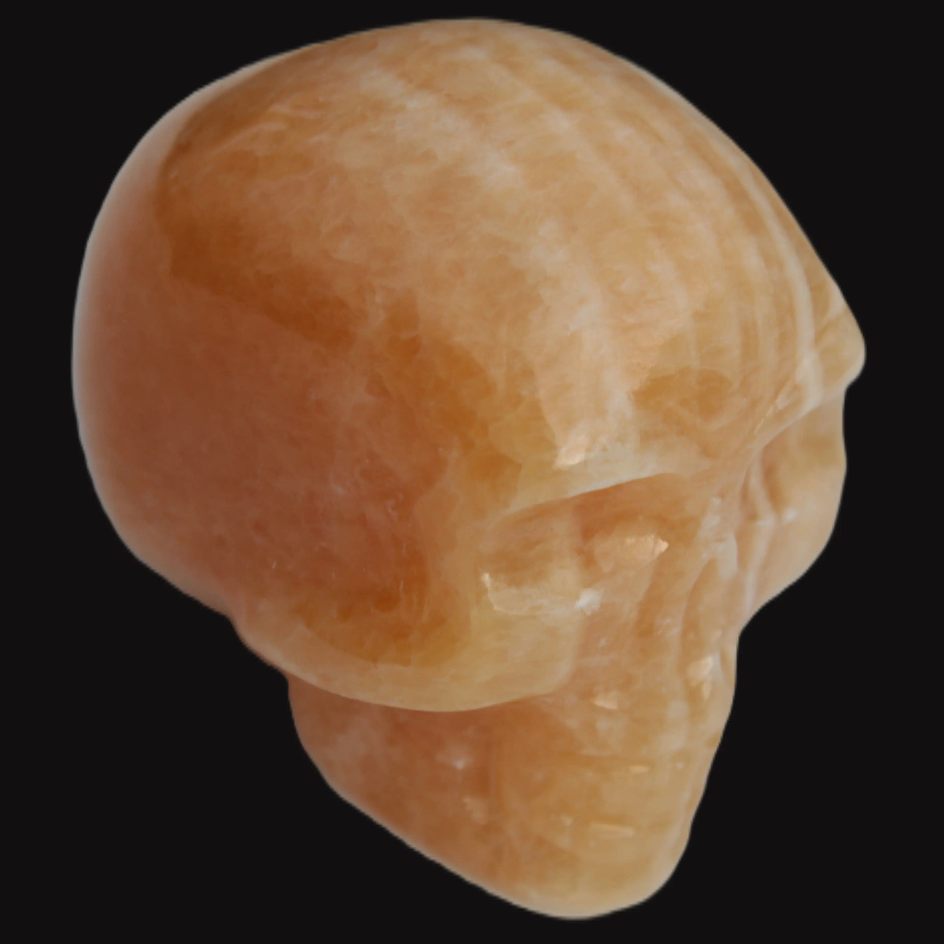 Banded Yellow Calcite skull 49mm 185.6g in sunlight - Rocks and Things Store