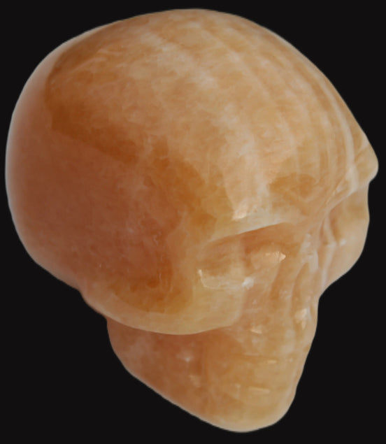 Banded Yellow Calcite skull 49mm 185.6g in sunlight - Rocks and Things Store