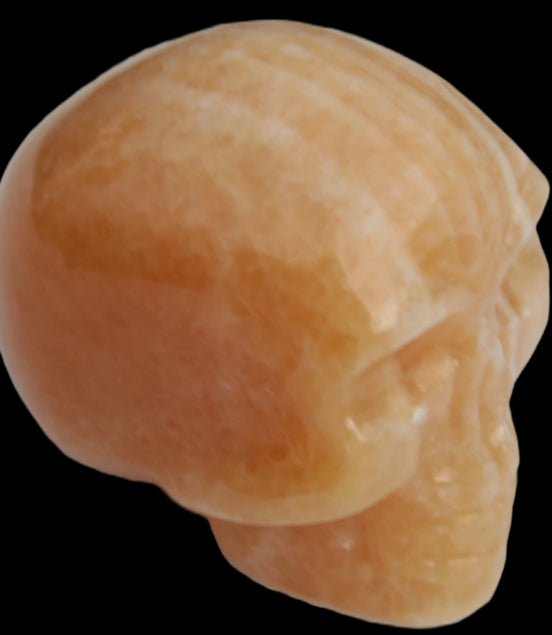 Banded Yellow Calcite skull 49mm 185.6g in sunlight - Rocks and Things Store