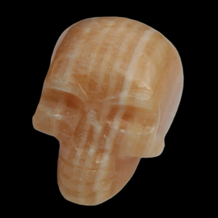 Banded Yellow Calcite skull 49mm 185.6g in sunlight - Rocks and Things Store