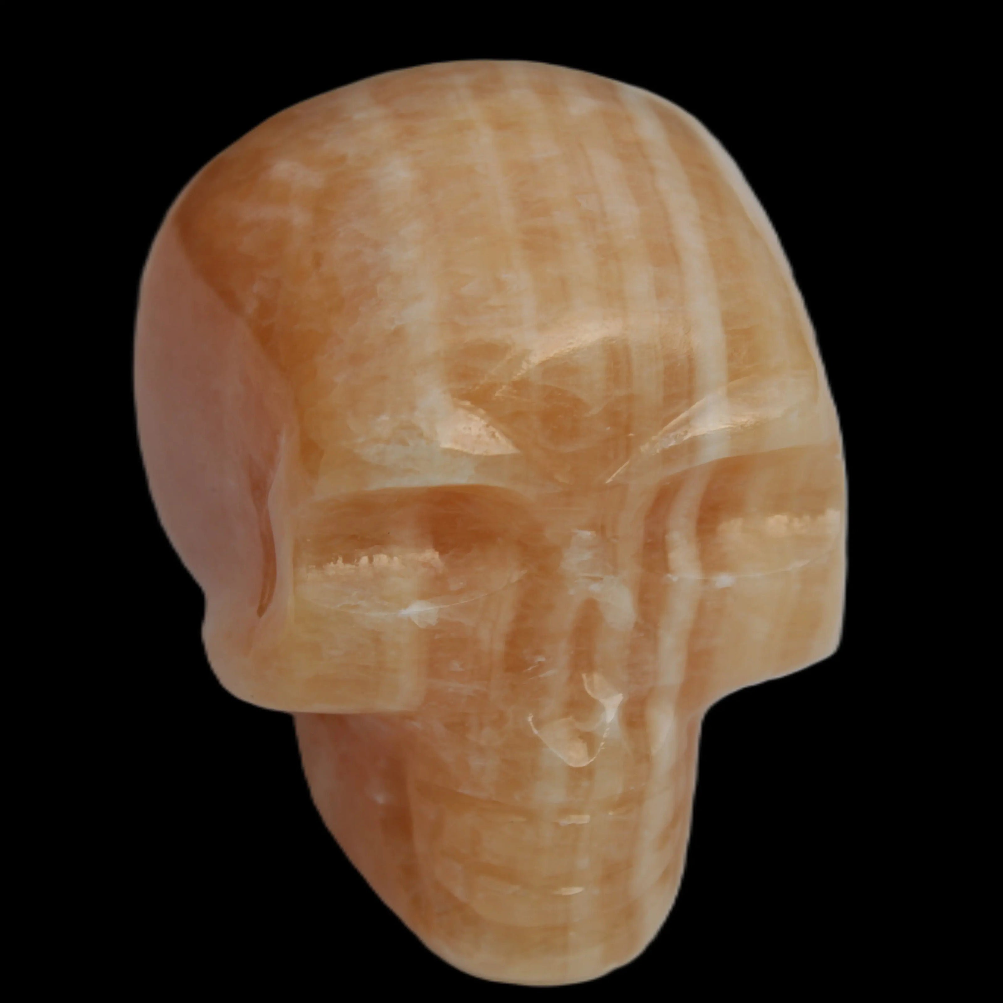 Banded Yellow Calcite skull 49mm 185.6g in sunlight - Rocks and Things Store