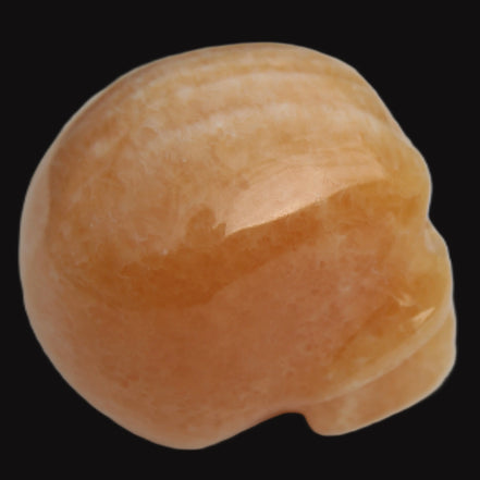 Banded Yellow Calcite skull 49mm 185.6g in sunlight - Rocks and Things Store