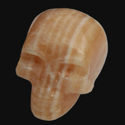 Banded Yellow Calcite skull 49mm 185.6g in sunlight - Rocks and Things Store