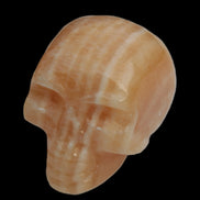 Banded Yellow Calcite skull 49mm 185.6g in sunlight - Rocks and Things Store