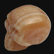 Banded Yellow Calcite skull 49mm 185.6g in sunlight - Rocks and Things Store