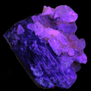 Black Tourmaline with Feldspar Quartz UV reactive matrix 88.2ct 17.7g in UV light -  Rocks and Things Store