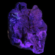 Black Tourmaline with Feldspar Quartz UV reactive matrix 88.2ct 17.7g in UV light -  Rocks and Things Store