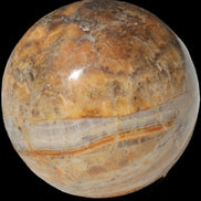 Calcite banded sphere 180g in sunlight - Rocks and Things Store