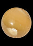 Honey Calcite sphere 47mm 162g in sunlight - Rocks and Things Store