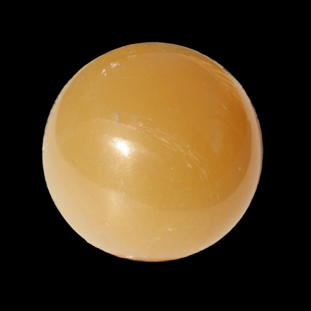 Honey Calcite sphere 47mm 162g in sunlight - Rocks and Things Store