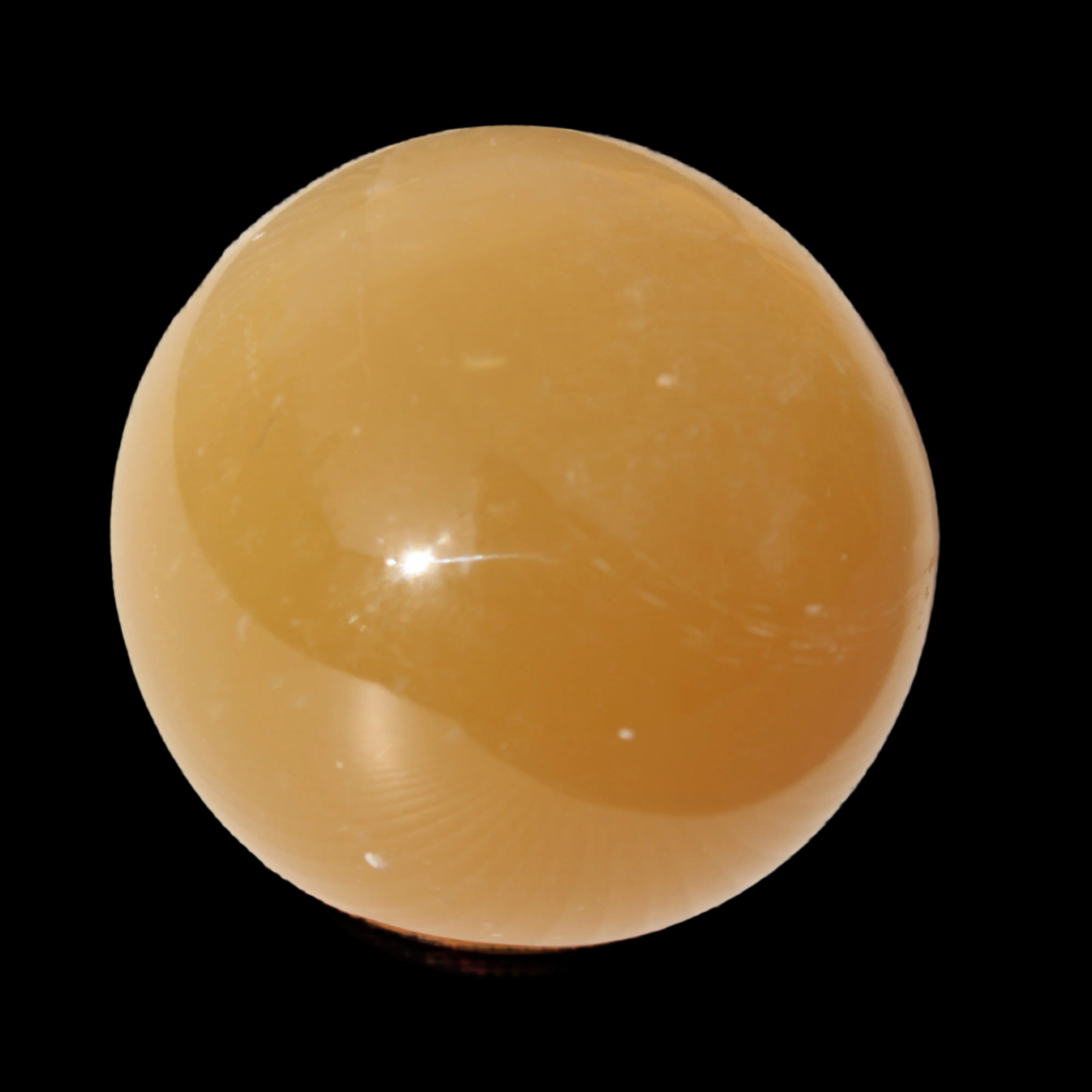 Honey Calcite sphere 47mm 162g in sunlight - Rocks and Things Store